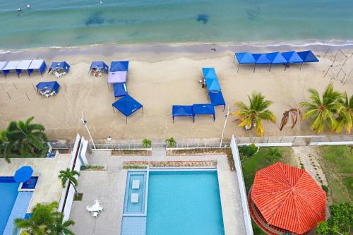 eine Luftansicht auf einen Strand mit Stühlen und Sonnenschirmen in der Unterkunft Magico Apartamento Frente al Mar 4 Habitaciones PV81 in Coveñas