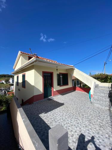 a small house with a staircase in front of it at Maria Holiday House in São Jorge