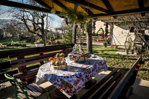 a wooden bench with a table with a basket of shoes on it at Bukovički mir in Arandjelovac