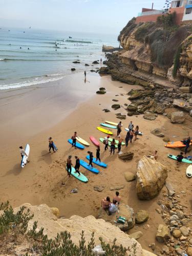 a group of people on a beach with surfboards at Surf Break Morocco in Imsouane