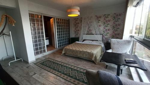 a bedroom with a bed and a chair and a table at Gölyaka Hotel in Bursa