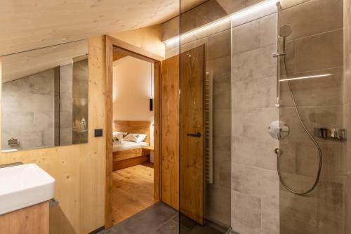 La salle de bains est pourvue d'une douche et d'un lavabo. dans l'établissement Ferienwohnungen Nigsch, à Schoppernau