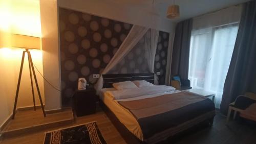 a bedroom with a bed and a large window at Gölyaka Hotel in Bursa
