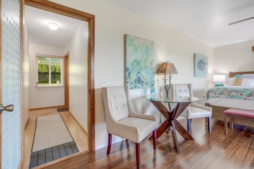 a bedroom with a table and chairs and a bed at Marjorie's Kauai Inn in Lawai