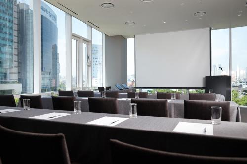 a conference room with a long table and chairs at Shilla Stay Ulsan in Ulsan