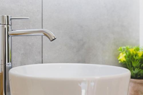 a bathroom with a sink and a faucet at Tra Lago Maggiore e lago d'Orta Appartamento ACQUA in Colazza