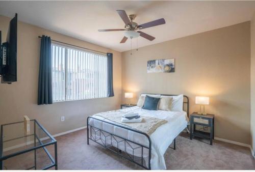a bedroom with a bed and a ceiling fan at Modern 2BR Oasis Pool, Gym & Parking Near Airport in Phoenix