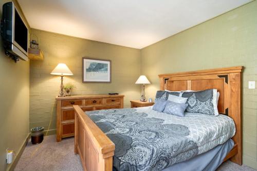a bedroom with a bed and a flat screen tv at Fantastic Steamboat Location With Amazing Views in Steamboat Springs