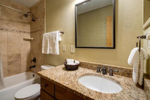 a bathroom with a sink and a toilet and a tub at Fantastic Steamboat Location With Amazing Views in Steamboat Springs