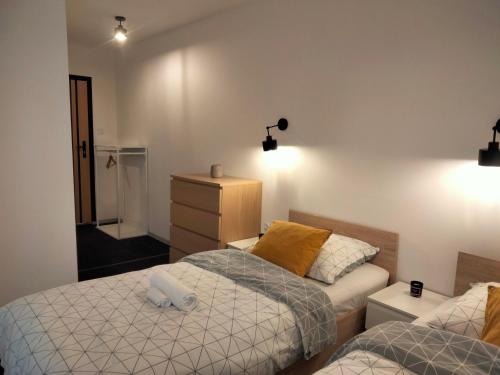 a bedroom with two beds and a dresser at U Gumisia in Korbielów