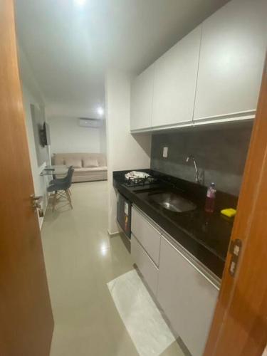 a kitchen with a sink and a counter top at Flat Santorini, beira-mar 206 in João Pessoa