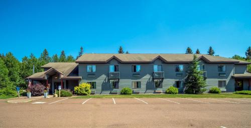 a large house with a parking lot in front of it at Mountain Inn at Lutsen in Lutsen