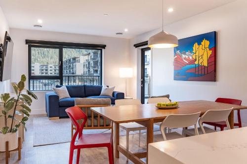 a living room with a table and a couch at Hygge Haus by Revelstoke Vacations in Revelstoke