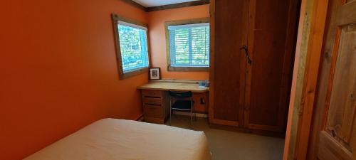 a bedroom with a bed and a desk and a sink at Gondola Village by Whistler Premier in Whistler