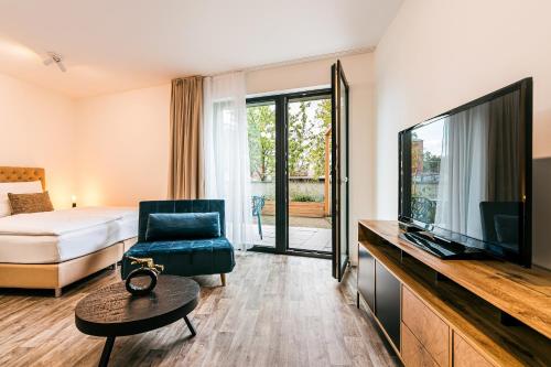 a hotel room with a bed and a television at Apartman Mikulov Garden in Mikulov