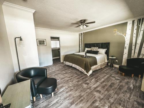 a hotel room with a bed and a chair at Woody Mountain Bed & Breakfast in Flagstaff