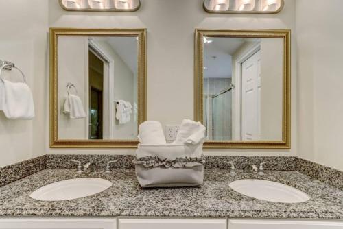 La salle de bains est pourvue de 2 lavabos et de 2 miroirs. dans l'établissement Comfort and Style at AIP Resort, à Amelia Island