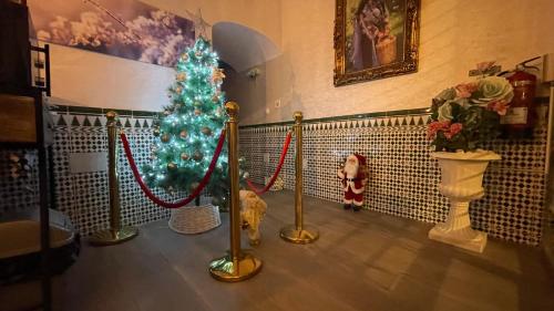 a christmas tree in a room with a dog at Hotel Boutique Andalucia in Fuengirola