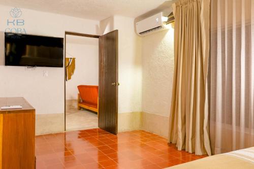 a bedroom with a bed and a sliding glass door at Kaab Coba in Cobá