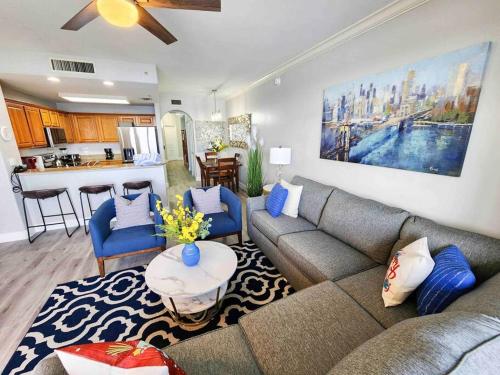 a living room with a couch and a kitchen at Lakeview newly renovated condo near Disney in Orlando