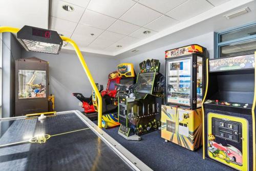 a room with arcade games and a video game system at Lakeview newly renovated condo near Disney in Orlando