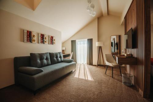 a living room with a couch and a table at PENSIUNEA GAMBRINUS **** in Miercurea-Ciuc