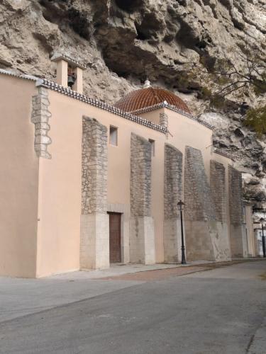 a church built into the side of a mountain at Coves Del Xuquer in Jorquera