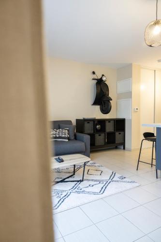 un salon avec un canapé et une table dans l'établissement Charmant studio en résidence avec parking, à Bussy-Saint-Georges