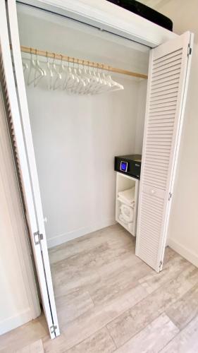 a room with a closet with a door open at Eleuthera Retreat - Private Villa & Cottages on pink sand beachfront in North Palmetto Point
