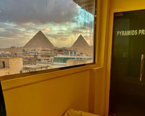 a view of the pyramids from the window of a room at Pyramids Pride Inn in Cairo