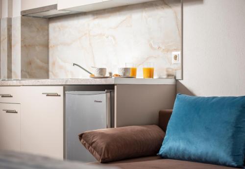 a kitchen with a couch next to a counter at VagAthan - Lux Holidays in Afitos
