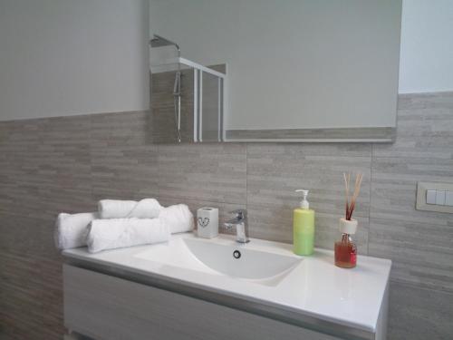 a bathroom with a white sink and a mirror at Casa Bijou in Pula