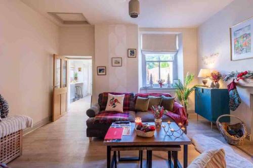 a living room with a couch and a table at Tranquil Appleby Retreat for 6 Guests with Hot Tub in Appleby