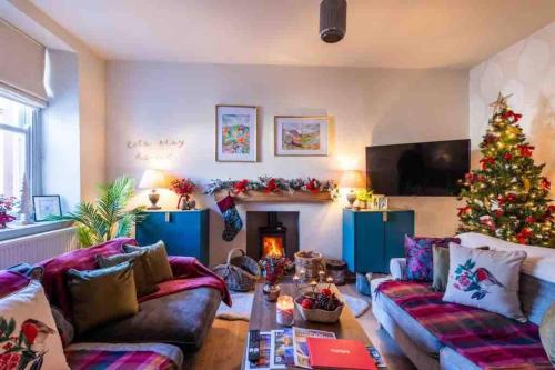 a living room with a christmas tree and a couch at Tranquil Appleby Retreat for 6 Guests with Hot Tub in Appleby