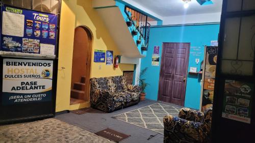 a hallway with two chairs in a building at Hostal Dulces Sueños in Panajachel