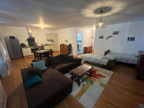 a living room with a couch and a table at Appartement en cœur de ville in Mauléon-Licharre