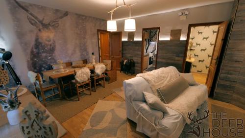 a living room with a couch and a table at Le Case Nel Bosco Terminillo in Terminillo