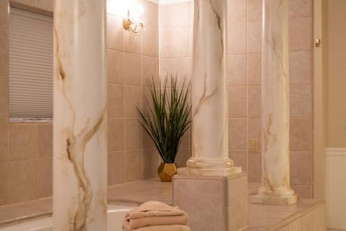 a bathroom with a shower with a plant in it at The Anniversary Inn - Boise in Boise