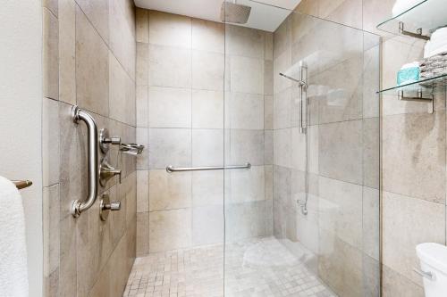 a bathroom with a shower with a glass door at Starry Waters Retreat in Sarasota