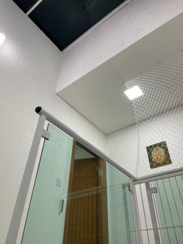 a bathroom with a shower and a glass door at The Brown beach House in Rio Grande