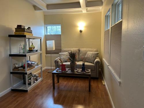 a living room with a couch and a table at Private room near Facebook, Amazon, Stanford in East Palo Alto