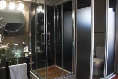 una ducha de cristal en un baño con inodoro en SAMARÁN SUITES, en Villa María