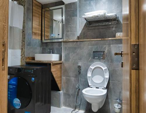 a bathroom with a toilet and a sink at Sunflower Residence Victoria Island in Lagos
