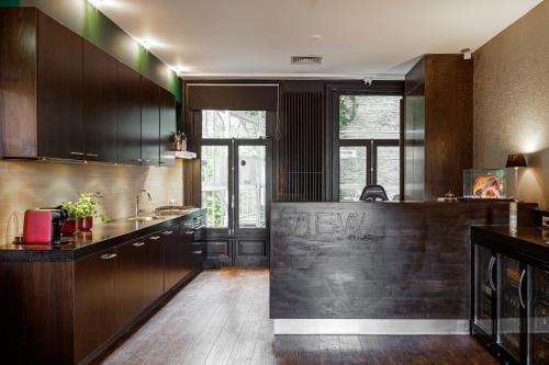 a kitchen with dark wood cabinets and a counter at Boutique Hotel View in Amsterdam