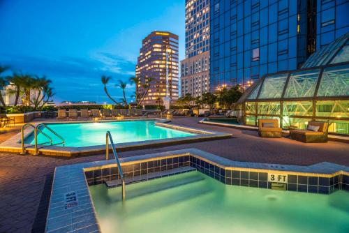 a swimming pool in the middle of a city at night at Hilton Tampa Downtown in Tampa