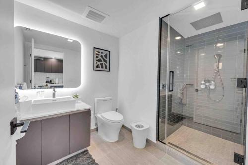a bathroom with a toilet and a sink and a shower at Breathtaking 1BR in the Heart Miami in Miami