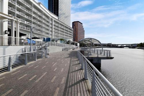 a walkway next to a building next to a body of water at Hotel Tampa Riverwalk in Tampa