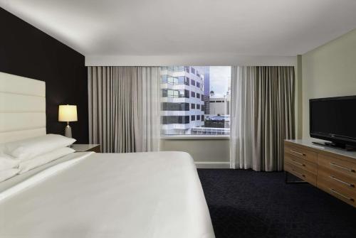 a hotel room with a bed and a television at Hotel Tampa Riverwalk in Tampa