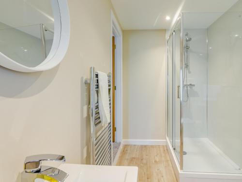 a bathroom with a shower and a sink and a mirror at Wester Caiplich - Uk30261 in Cray