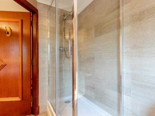 a shower with a glass door in a bathroom at Dalgarven Spa House in Dalry